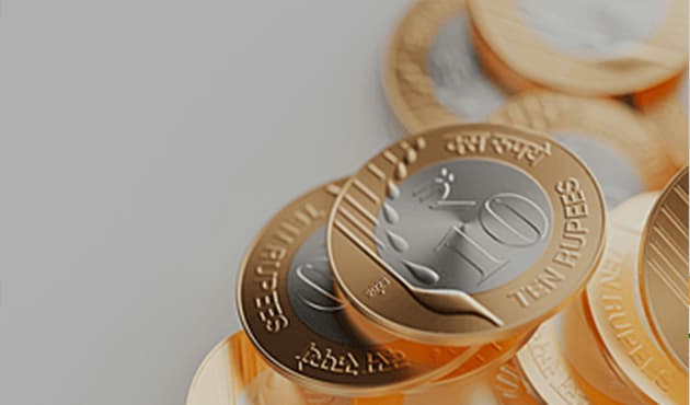 Close-up of stacked Indian rupee coins.